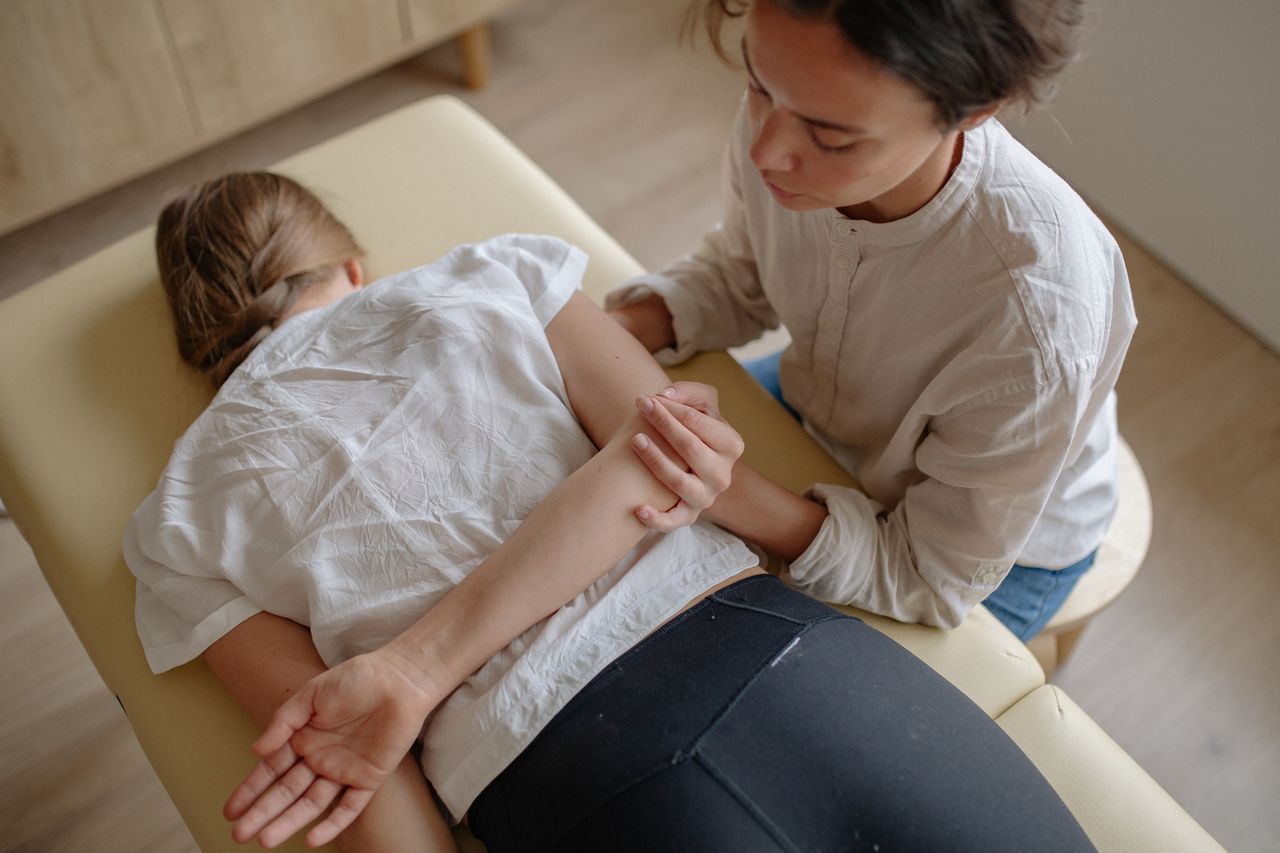 services-02 A woman receiving chiropractic treatment on a massage table for relaxation and health.